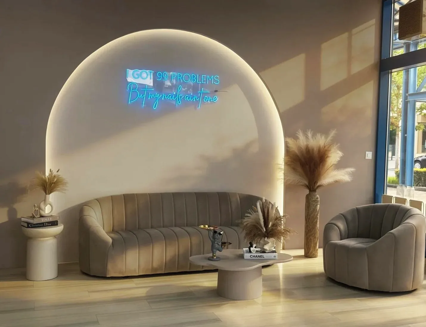Wartebereich mit Samtsofa und Neon-Schriftzug «I got 99 Problems but my Nails ain't One»